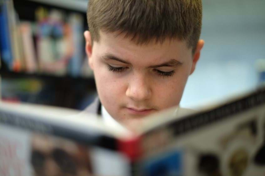 Sec - NLA - Boy Reading Close Up
