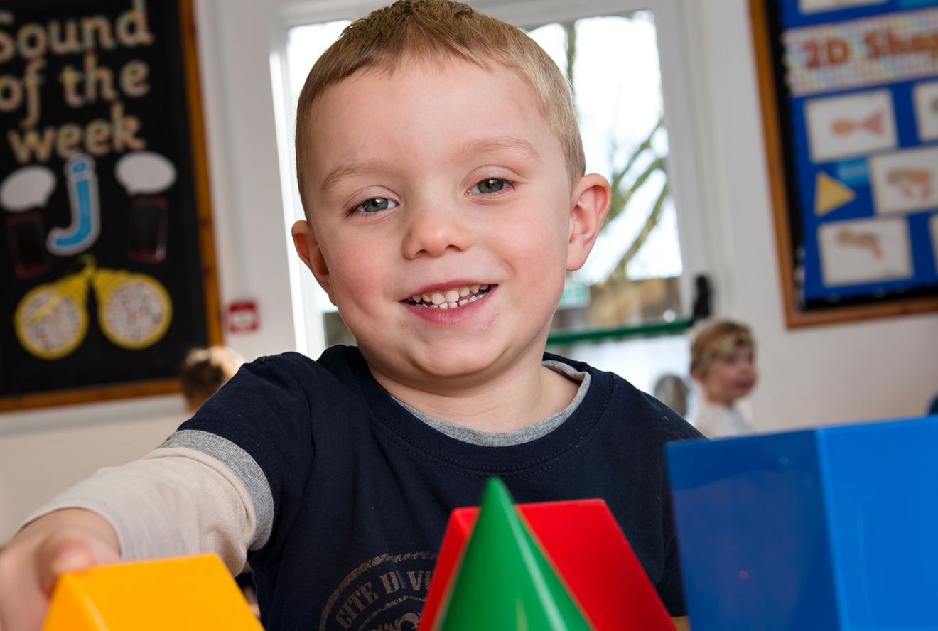 Early Years Boy With Blocks