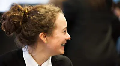 Teenage girl in uniform smiling.