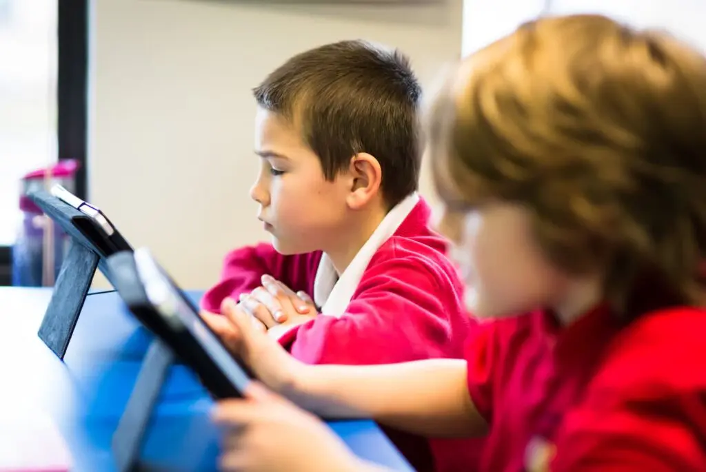 Students using tablets in a classroom.