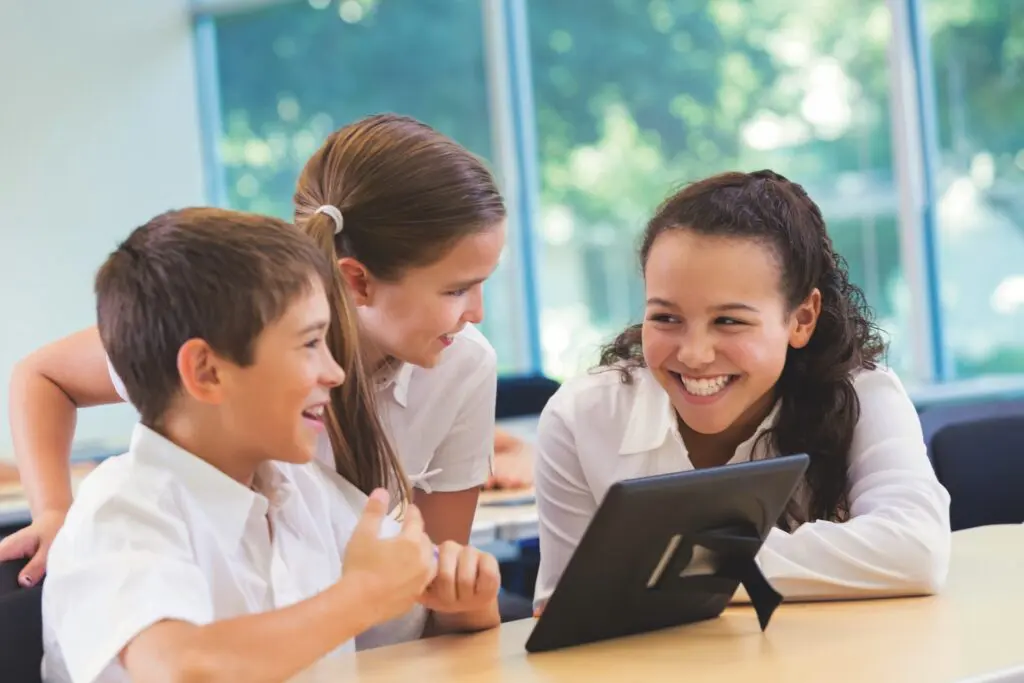 Smiling group of students using a tablet