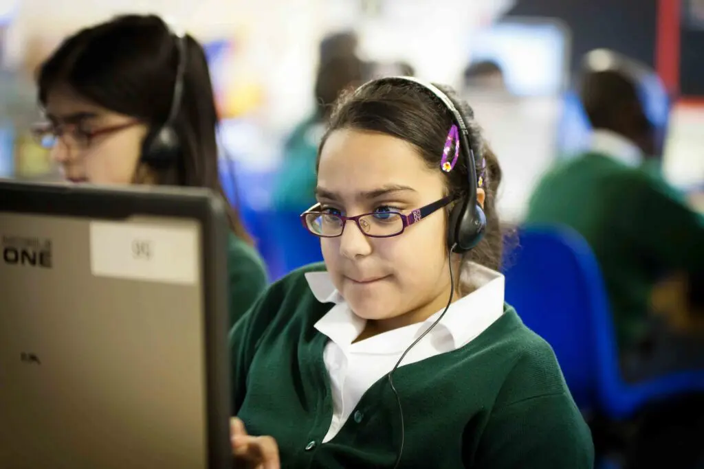 Student wearing headphones working at a computer